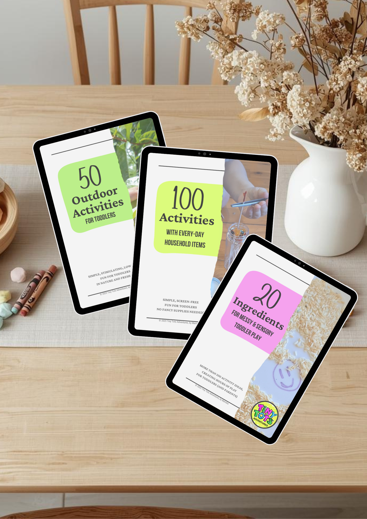 Three tablets displaying activity lists on a wooden table with a vase of flowers.