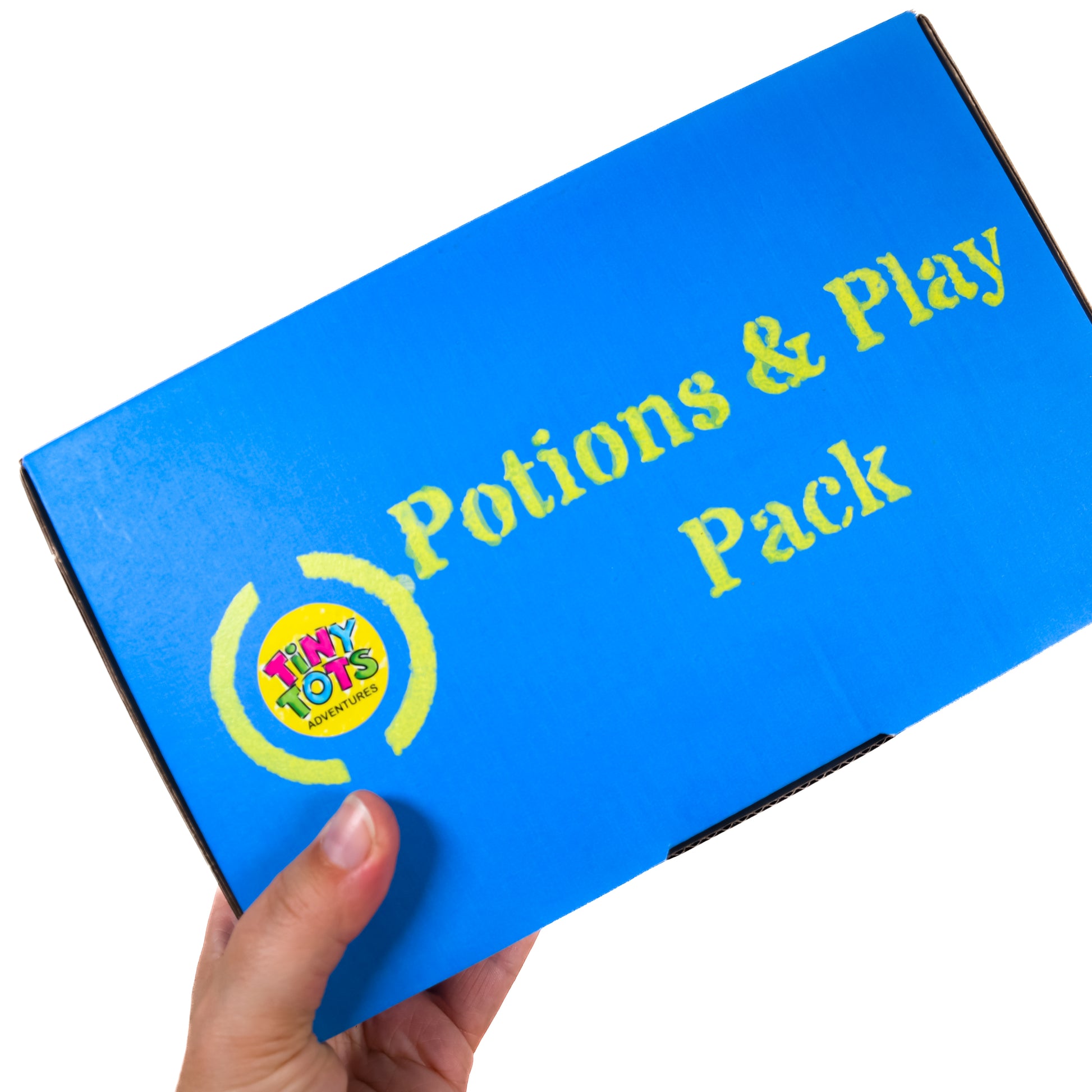 Blue box labeled 'Potions & Play Pack' with a hand holding it on a white background