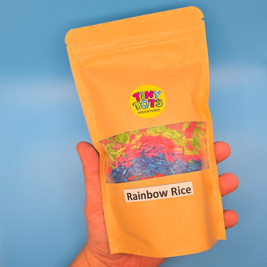 paper package of 'Rainbow Rice' with 'Tiny Tots' branding on a blue background